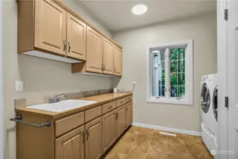 Laundry room is just off the garage man-door entry and kitchen area.  Big under stair closet too!