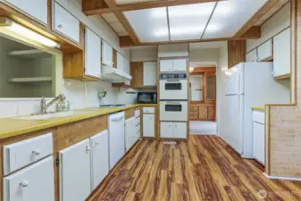 Spacious kitchen with an eating area and laminate floors.