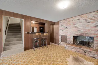 Rec room features wood fireplace and sliding door to exterior