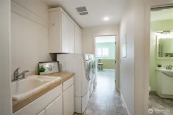 Utility room just off the kitchen with access to the crafts room, half bath and garage.