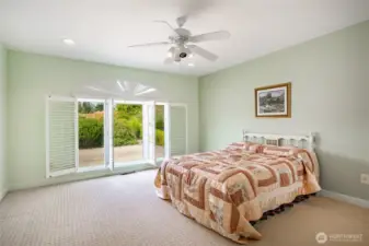 The other two guest bedrooms are on the opposite side of the main floor, on the fireplace side. See one guest bedroom with shutters open.