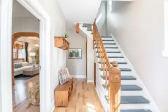 The entry features this gorgeous staircase with lovely newel posts. Lots of room to store outerwear including a coat closet under the stairs.