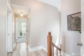 The upstairs landing with a peek at the 3rd bedroom.