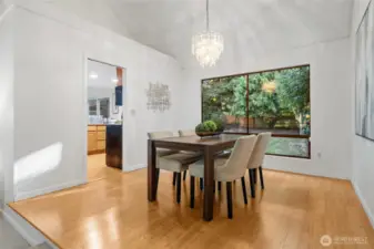 The dining room is thoughtfully elevated just a step up, creating a sense of separation and intimacy—while still maintaining an open, connected flow to both the living room and kitchen.
