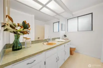 Conveniently located near the additional bedrooms, this full bathroom features ample counter space, plenty of storage, and natural light—ideal for daily use or accommodating guests with ease.