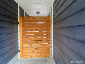 Outside between the house and the garage, privacy gate .