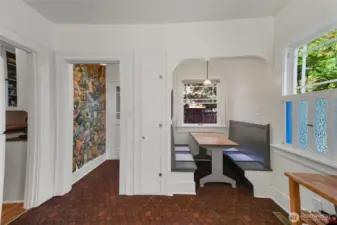 Unit B kitchen with built in eating nook, and side entrance.