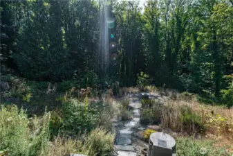 Follow the stone path lined with lavender to the cozy fire pit, then around the house for a peaceful garden walk.