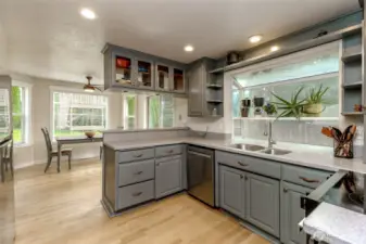 Kitchen has trendy painted cabinets and glass faces.