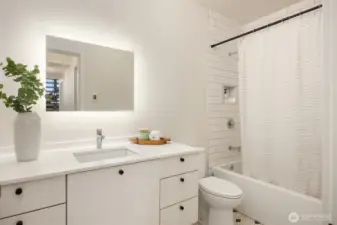 The full bathroom shared by bedrooms #2 and #3 boasts the same high-quality details and finishes