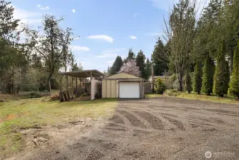 Detached garage with RV covered carport