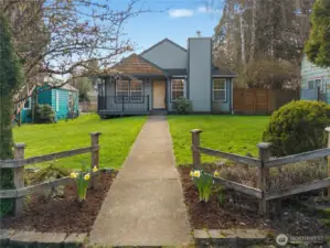 Welcoming front approach is framed by mature landscaping and a broad front lawn.
