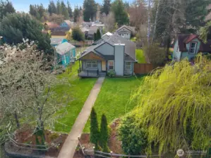 Aerial view highlights the home’s generous yard, and mature landscaping.
