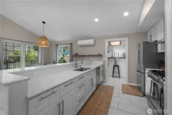 Updated kitchen features quartz counters, stainless appliances, and generous prep space.