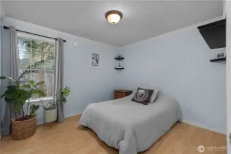 Bright secondary bedroom offers comfortable space for guests, office use, or everyday living.