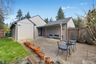 Private backyard retreat with covered entry, patio space, and detached garage access.