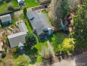 Bird’s-eye view showcases the lot, home footprint, backyard patio, and alley access.