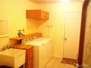The laundry room has a 5k Mahogany door with leaded glass, and the room is not really yellow but somehow the photo looks yellow.