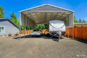 This huge, tall and wide covered carport has room for RVs, boats, personal watercraft, skidoos, extra cars, and whatever else you have that needs to be covered.