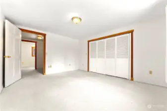 Primary bedroom Upper level of home is carpeted. Large closet. Tons of natural light. Super quiet and relaxing space. Wood trim around windows and doors.