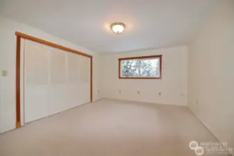 Primary bedroom is carpeted with large closet. Natural light on south side of home comes through the window for refreshing relaxed space.