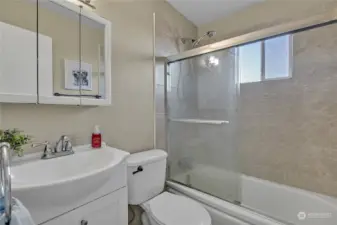 The remodeled full bathroom is located close to the secondary bedrooms. Nicely done with tile accents!