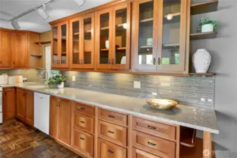 Kitchen has been luxuriously updated with cherry cabinets and lengthy quartz countertops