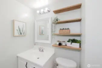 Full upstairs bathroom with charming built in shelves and tiled-in tub.