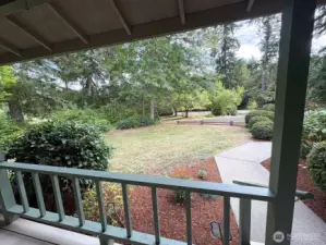 Covered porch overlooks the spacious front grounds—perfect for morning coffee.