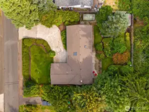 Top-down view of home and property shows greenhouse to the side of home, additional storage shed at the back of property.
