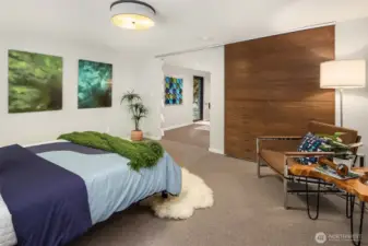 Sleek sliding barn door between bedroom and living space to maximize space
