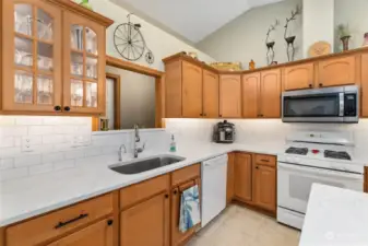 The elegant kitchen is finished flawlessly with gorgeous cabinets with under mounted lights, subway tile backsplash, insta hot water dispenser and large sink!