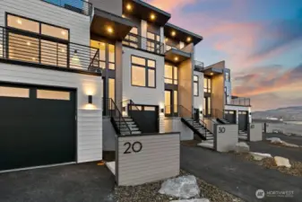 Gorgeous townhomes featuring expansive windows, ample parking, and multiple outdoor decks.