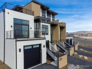 Gorgeous townhomes featuring expansive windows, ample parking, and multiple outdoor decks.