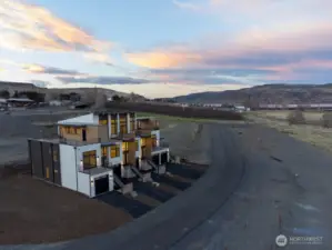 Gorgeous townhomes featuring expansive windows, ample parking, and multiple outdoor decks.