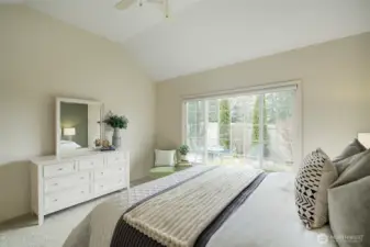 The Primary Bedroom features windows that overlook the landscaped patio area.