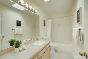 Adjacent to the upstairs bedroom is another full-sized bath.