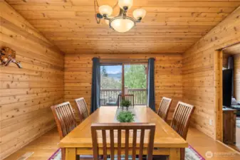 Dining room that includes access to one of the home's decks that overlook the rest of the property.