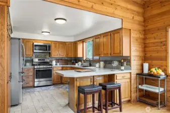Bar stool seating and additional storage on the outside of the peninsula. Newer appliances in this good sized kitchen.
