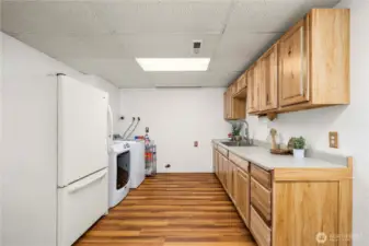 Lower level kitchenette and laundry area. Fully updated cabinets and countertop.