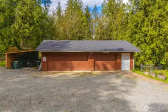 Roughly 900 sq foot detached 3 car garage with additional carport parking/storage.