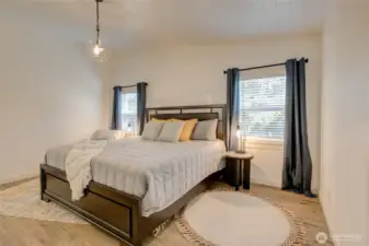 Spacious master bedroom with a vaulted ceiling, adding an open airy feel.