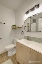 Main bathroom features a tile backsplash for a clean modern look.