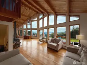 Soaring ceiling & stunning wall of windows with beautiful water & mountain views.