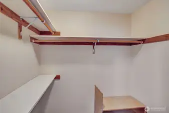 Walk-in closet in primary bedroom.