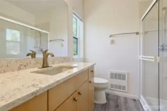 Primary bath with quartz countertops.