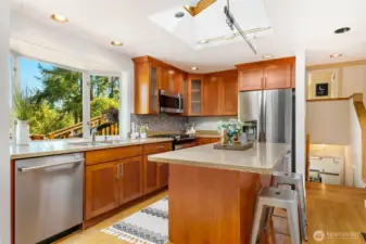 pen cherry kitchen with granite and stainless steel appliances.