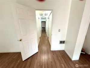 Lower level hallway 2 bedrooms accross from each other, laundry, bathroom  another bedroom end of the hallway.