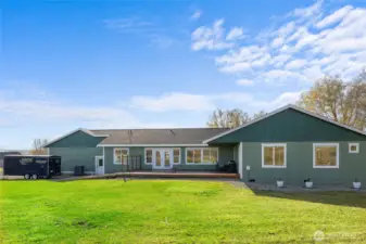 View of the back of the home with deck.