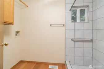 Laundry room off of garage entry with large tile walk in shower
